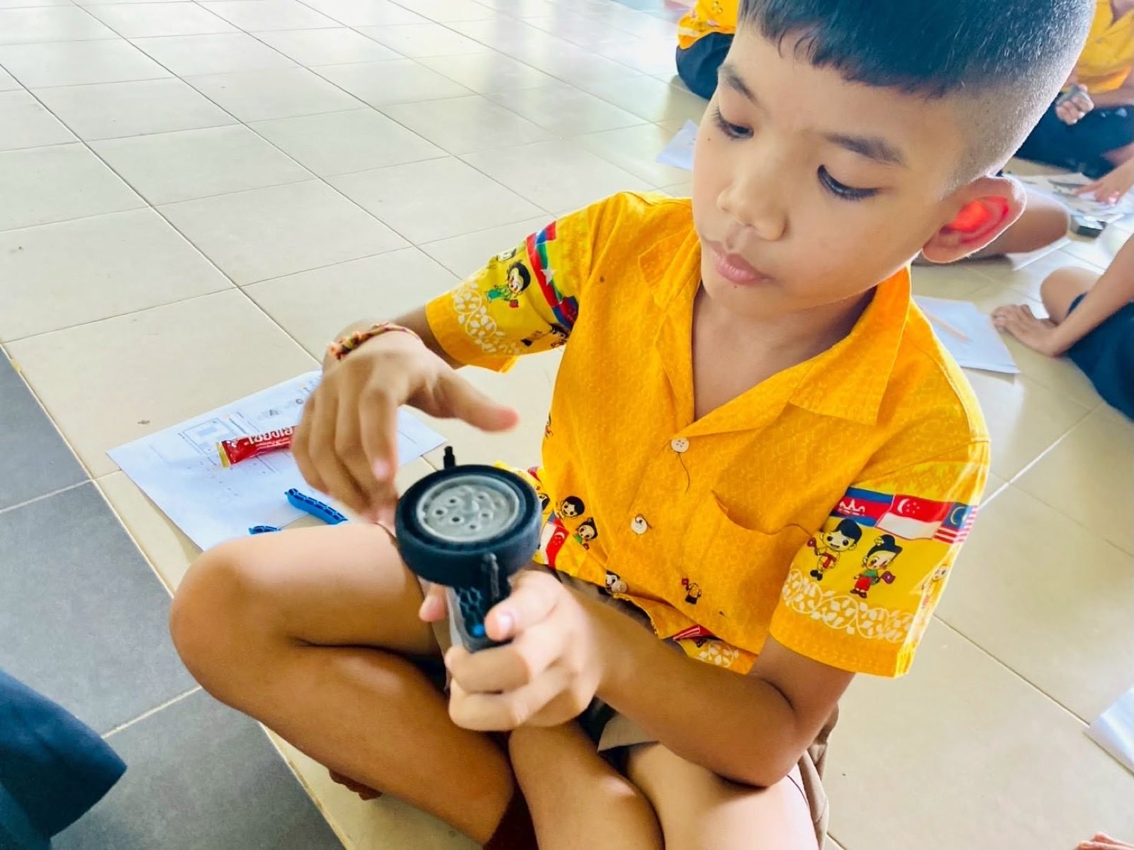 A student examining a VEX IQ wheel