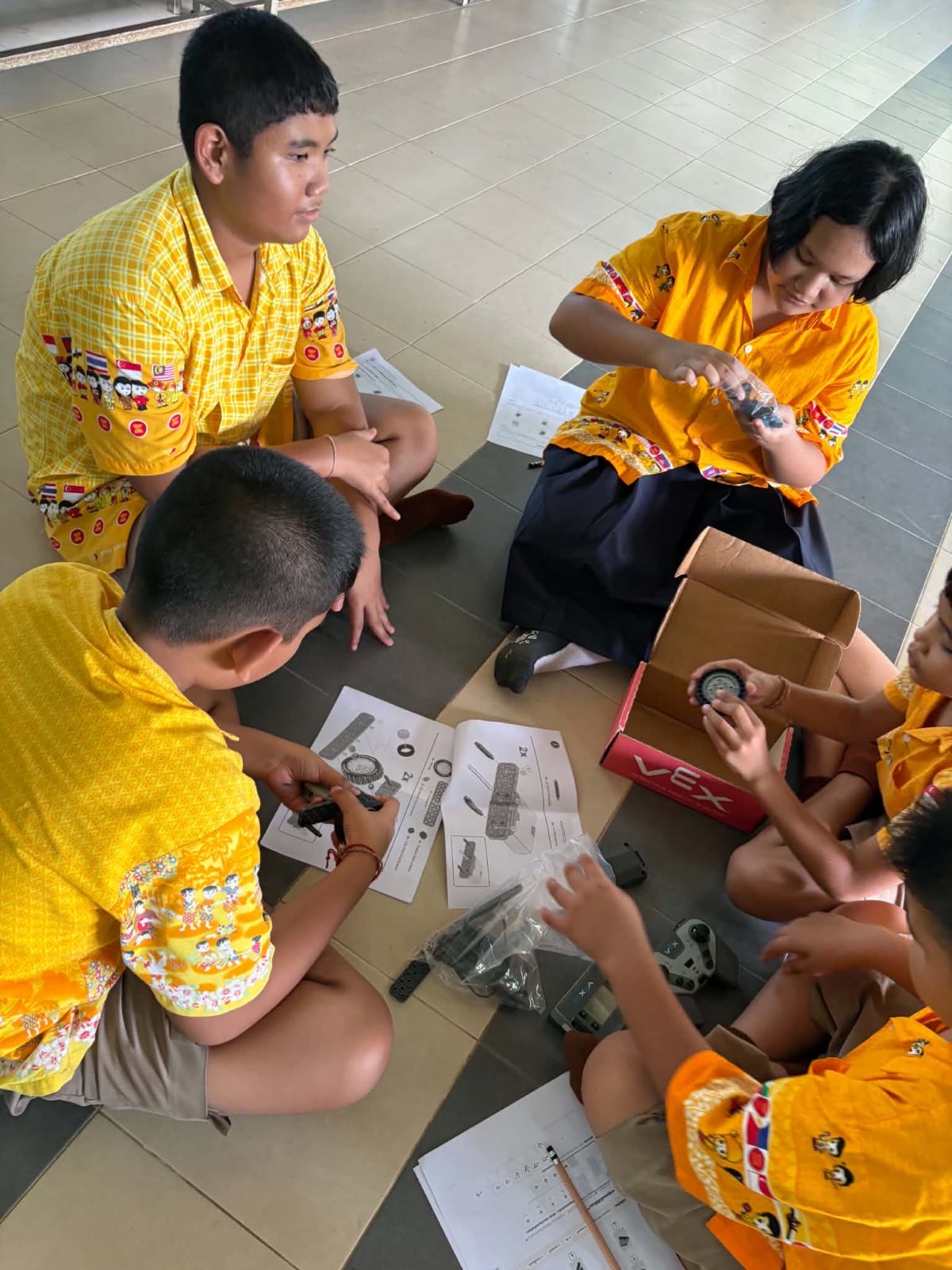 Students unboxing the VEX IQ kit and sorting the parts